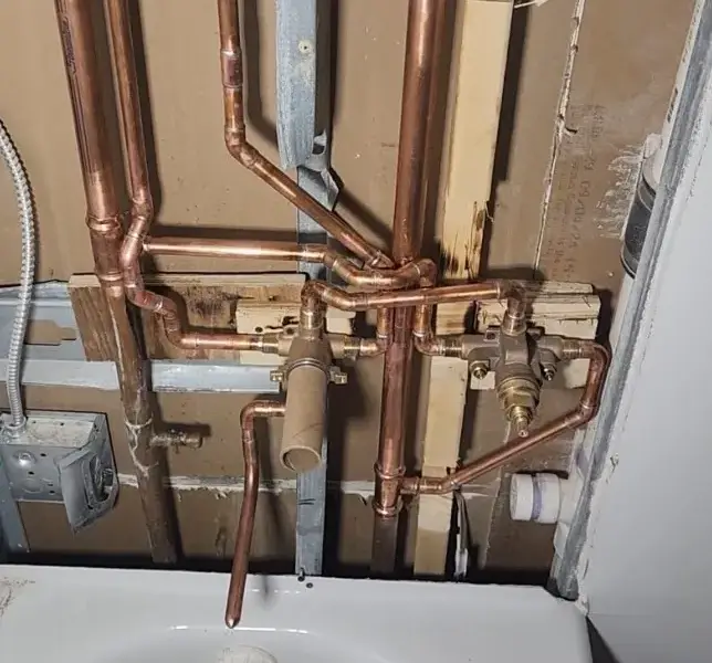 Shower valve rough-in during a hotel bathroom renovation