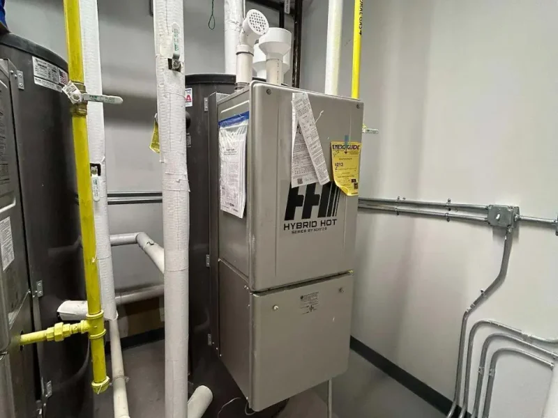 Commercial mechanical room with water heaters and new piping