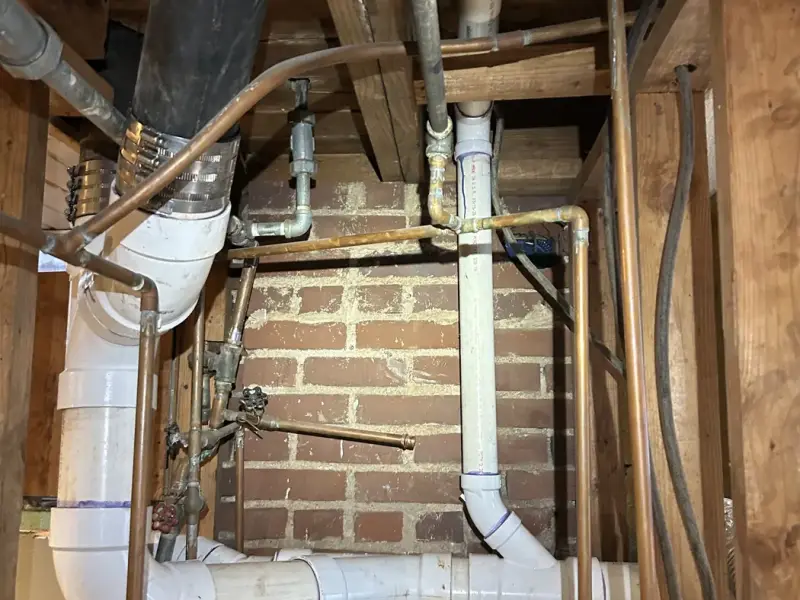 New PVC drain lines installed in a basement during a drain reroute
