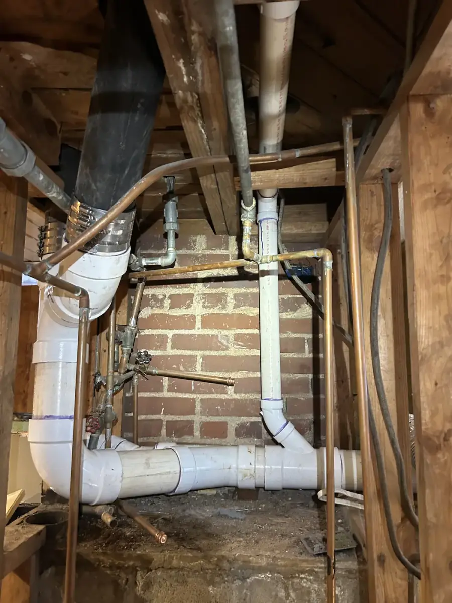 New PVC drain lines installed in a basement during a drain reroute