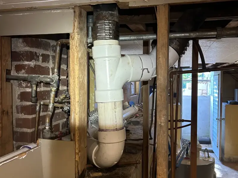 New PVC drain stack and fittings in a basement
