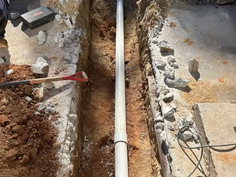 New PVC drain line laid in a trench
