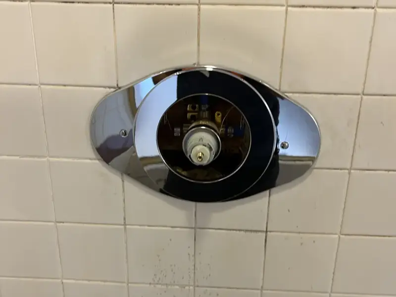 New chrome shower trim installed on tile after a repipe