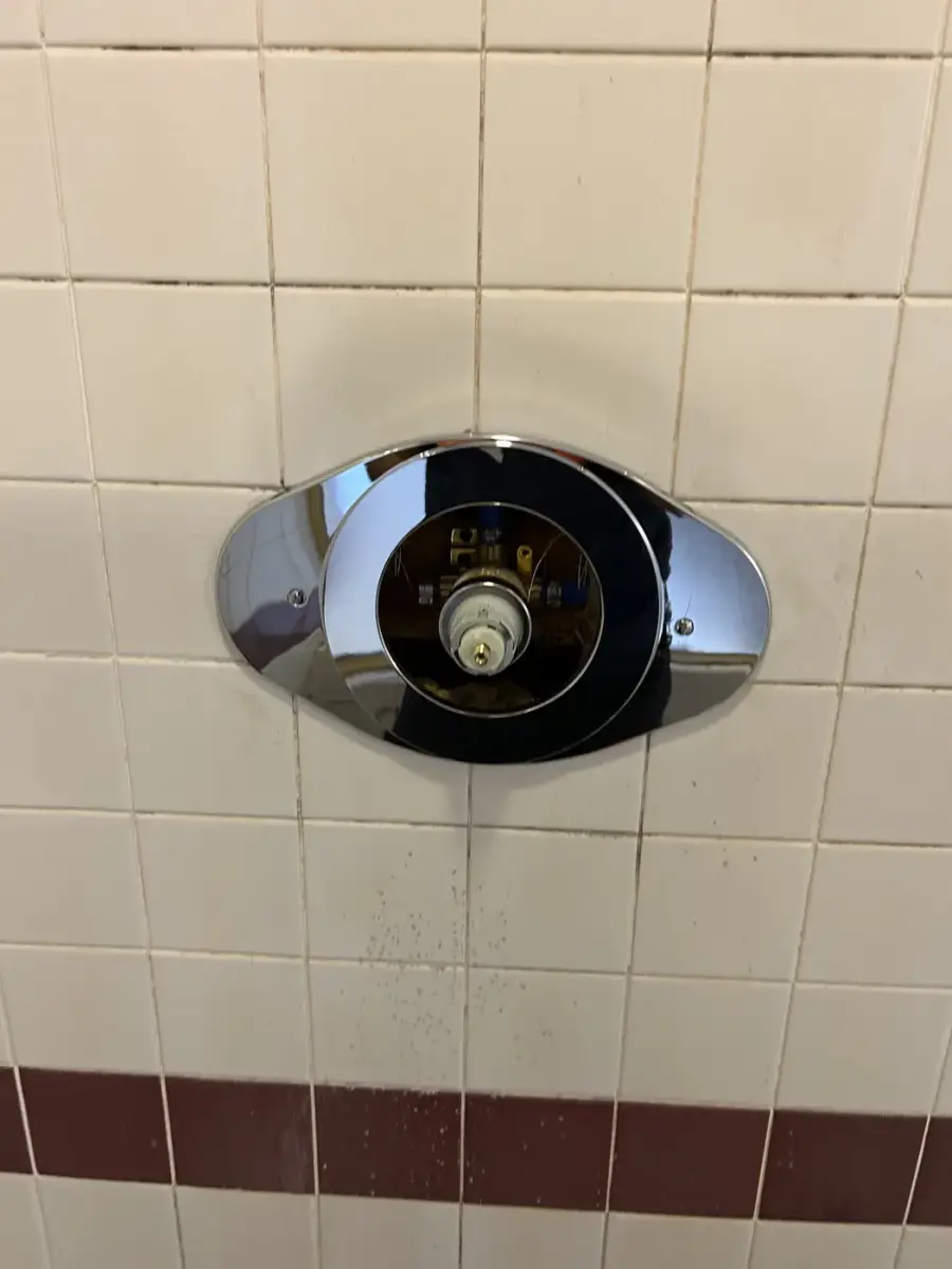 New chrome shower trim installed on tile after a repipe