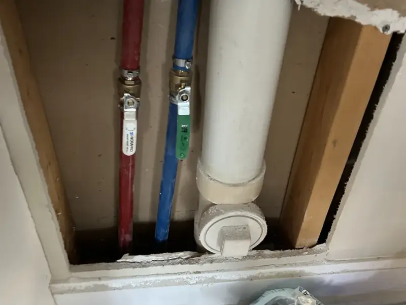 New PEX supply lines inside an opened wall during a whole-home repipe