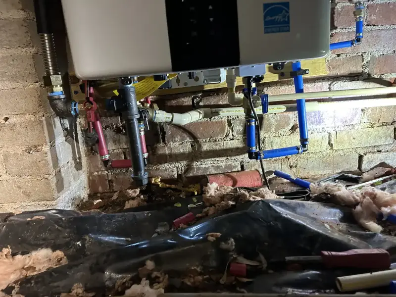 Gas, water and condensate connections under a new Navien tankless water heater