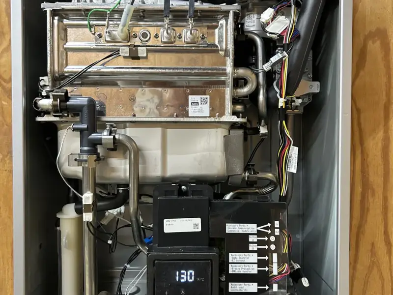 Tankless water heater opened up for service and repair