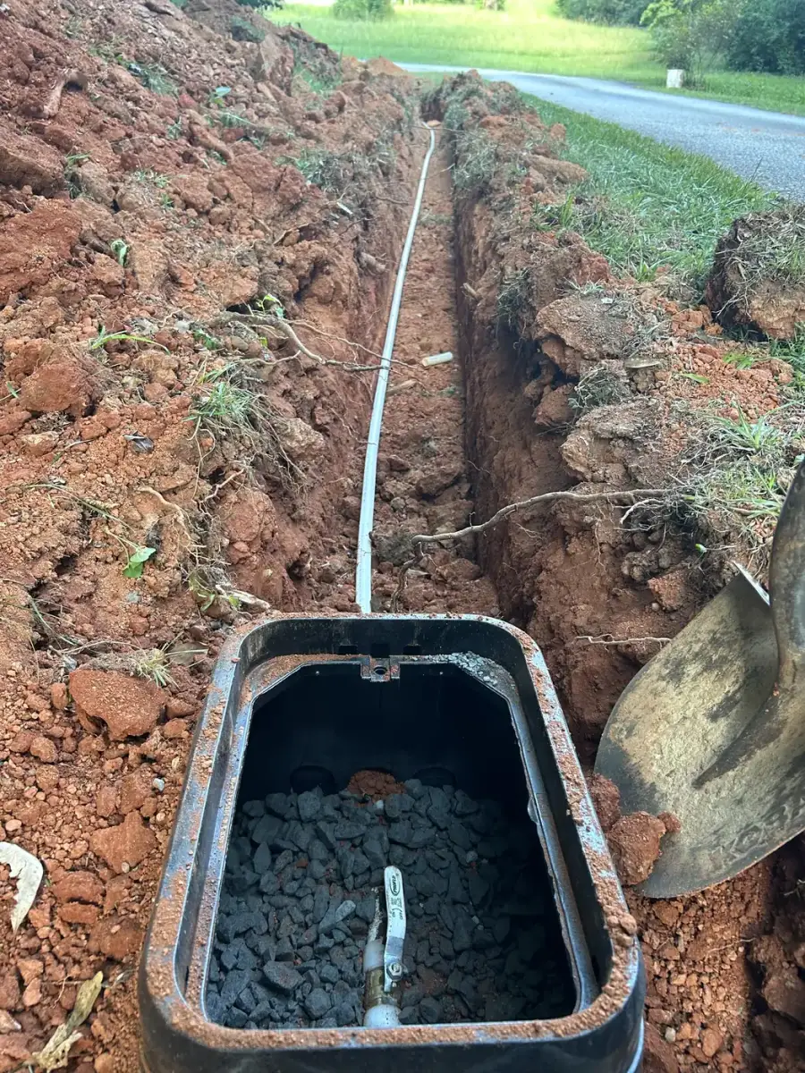 New water service line in a trench leading to the meter box