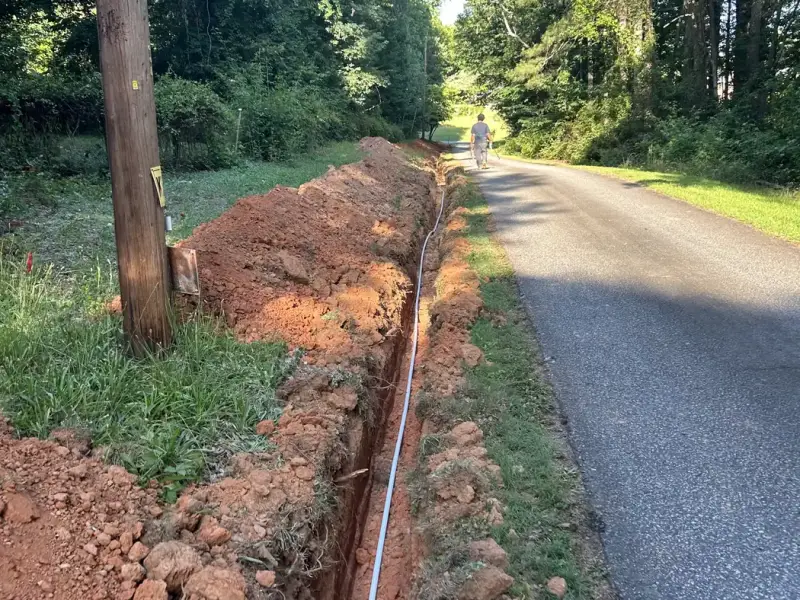 Long trench for a new main water line along a driveway