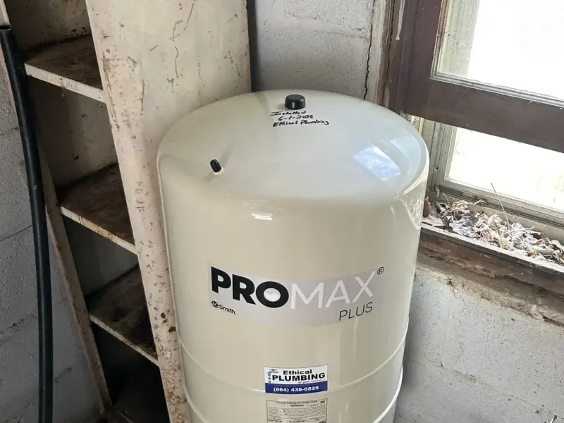 New well pressure tank installed at a pump house window