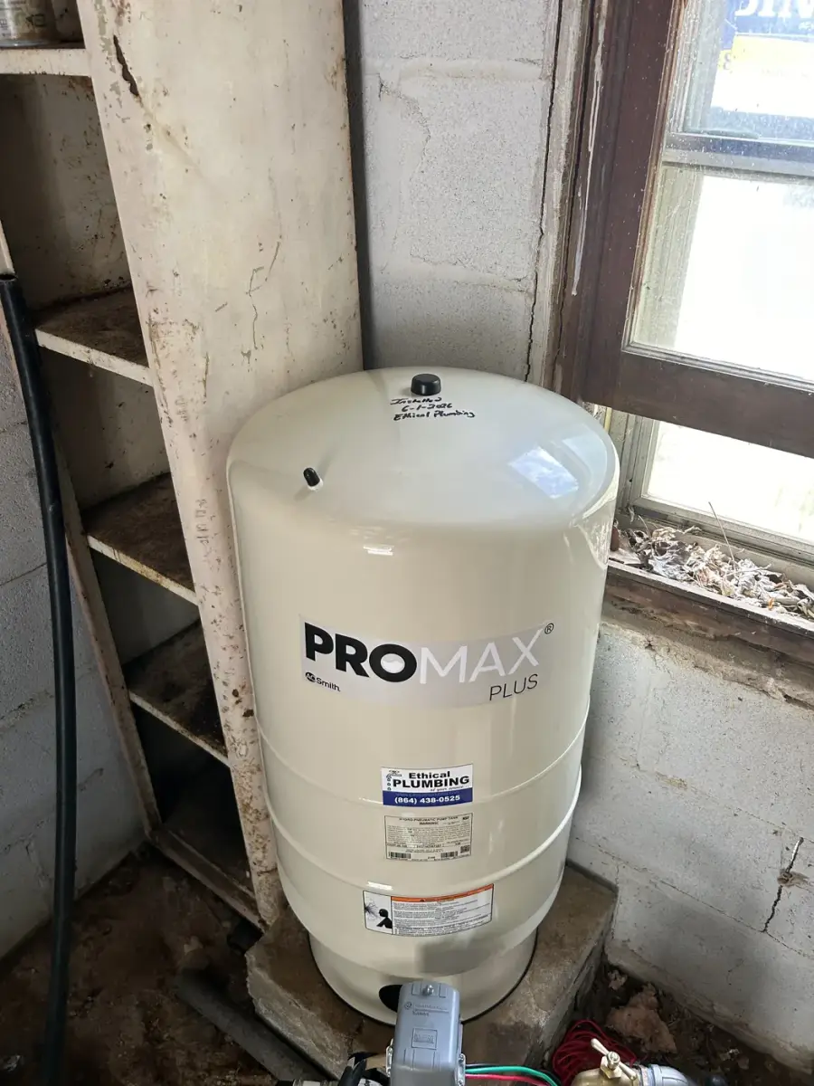 New well pressure tank installed at a pump house window
