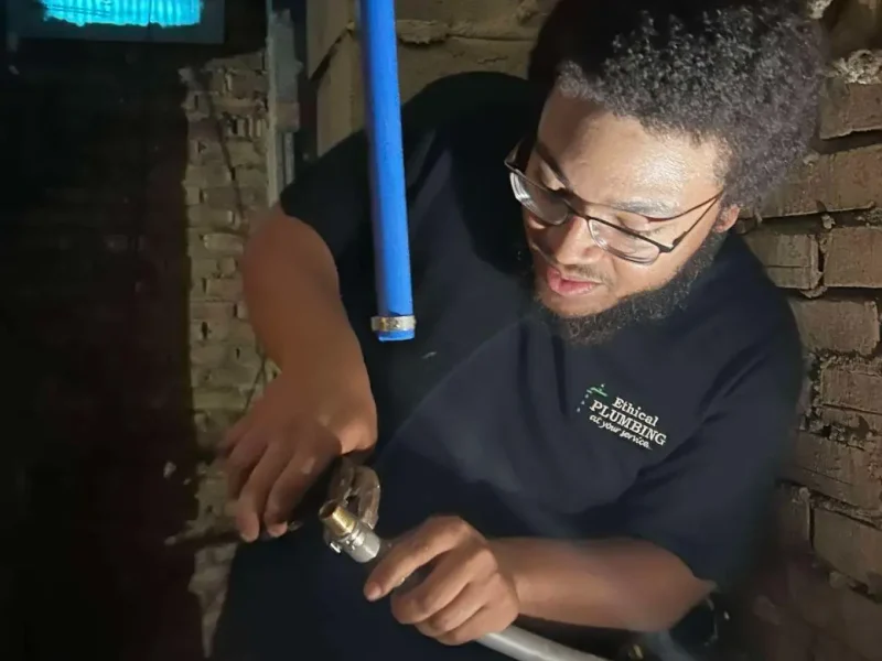 Plumber installing a water pressure reducing valve
