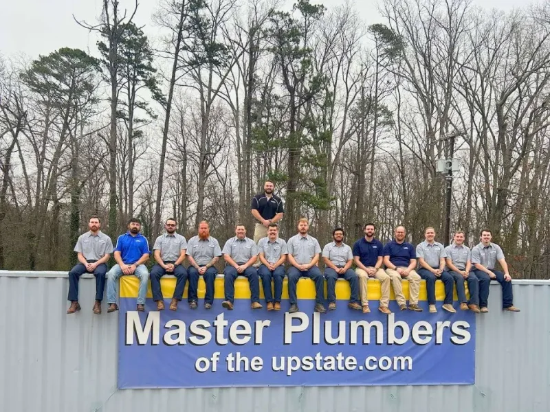 Ethical Plumbing plumbers seated in a row outdoors