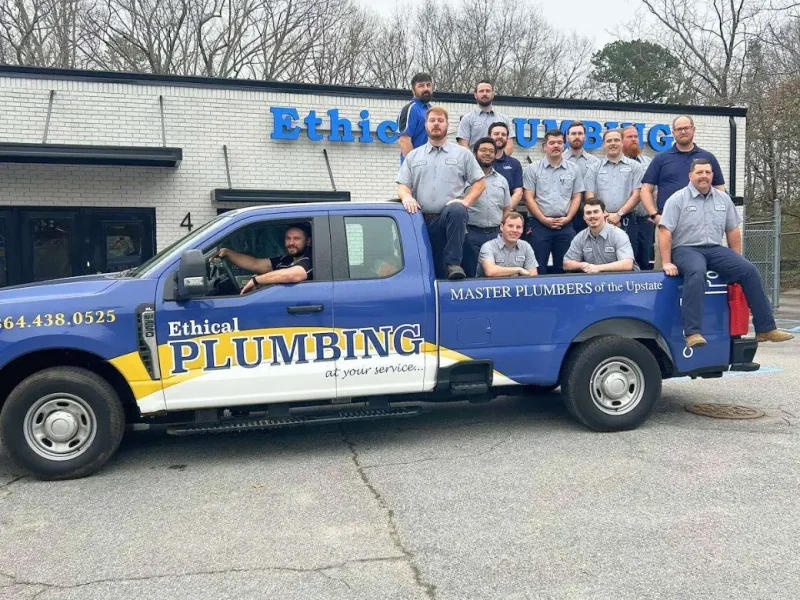 Ethical Plumbing team on a service truck outside the Taylors shop